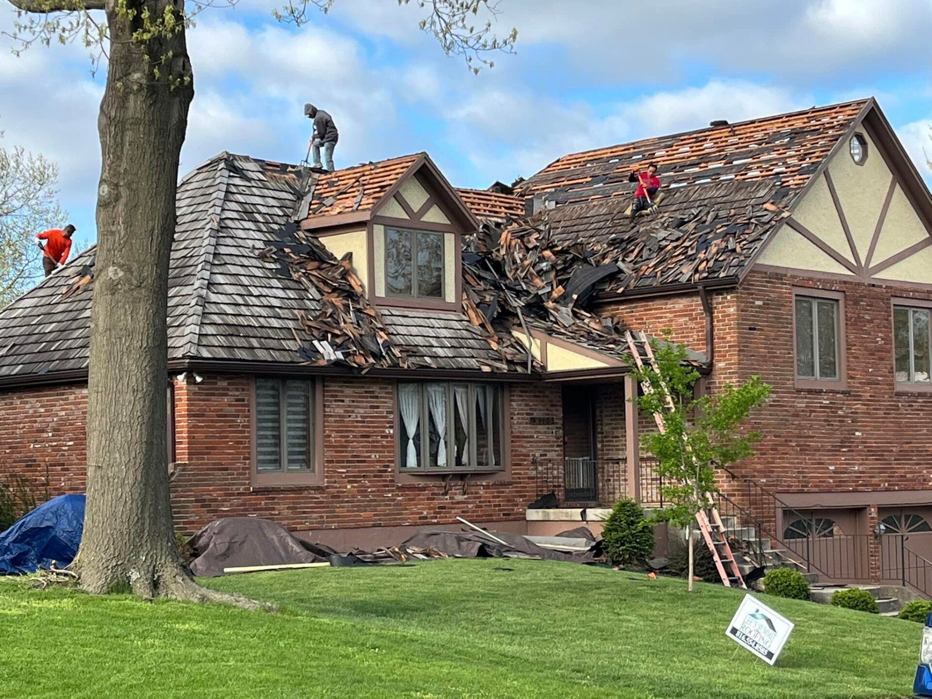 Roofers cleaning up storm damage