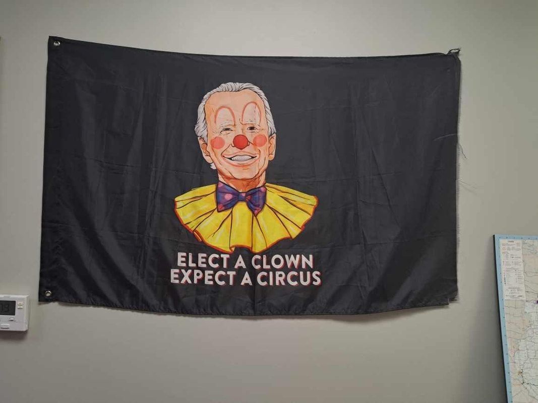Black banner with a clown face and the text “ELECT A CLOWN EXPECT A CIRCUS.”