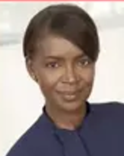 Smiling woman in a dark blue top against a light background