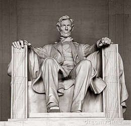 Seated Abraham Lincoln statue in the Lincoln Memorial, in a marble chair with draped robes