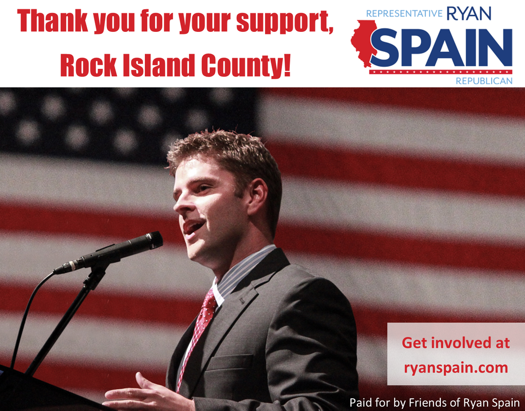 Ryan Spain speaking at a microphone with an American flag backdrop and campaign message, “Thank you for your support, Rock Island County!”