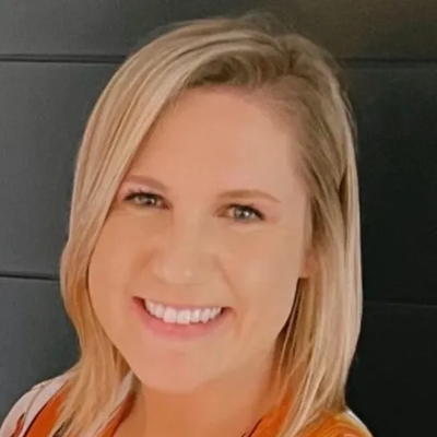 A woman with blonde hair is smiling for the camera.