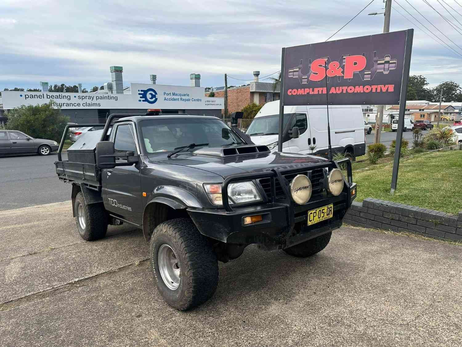 Pickup Truck Parked in A Repair Shop with A Sign of S&P Complete Automotive — S&P Complete Automotive in Port Macquarie, NSW