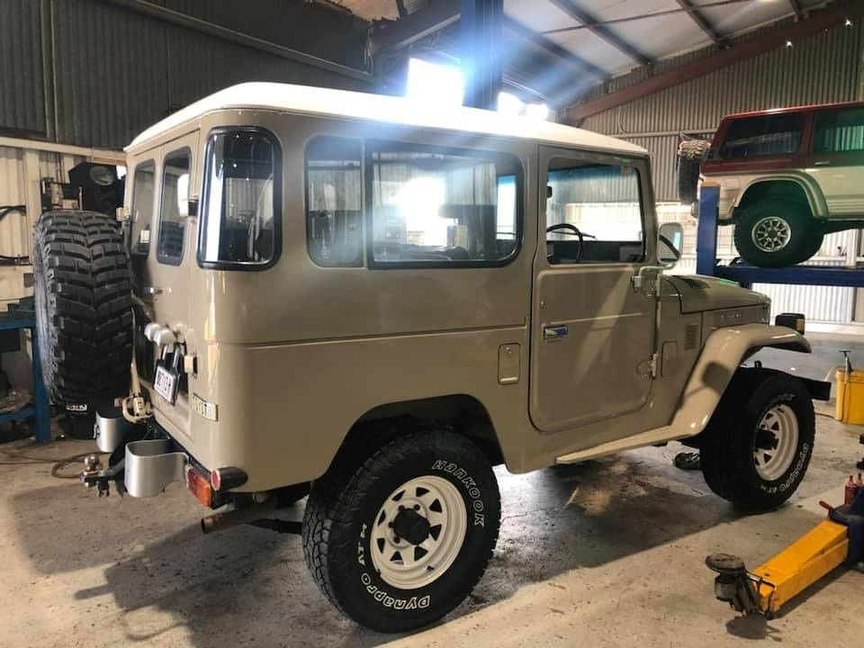 Tan Toyota Land Cruiser FJ40 in A Garage, White Roof, Spare Tire on Back — S&P Complete Automotive in Port Macquarie, NSW
