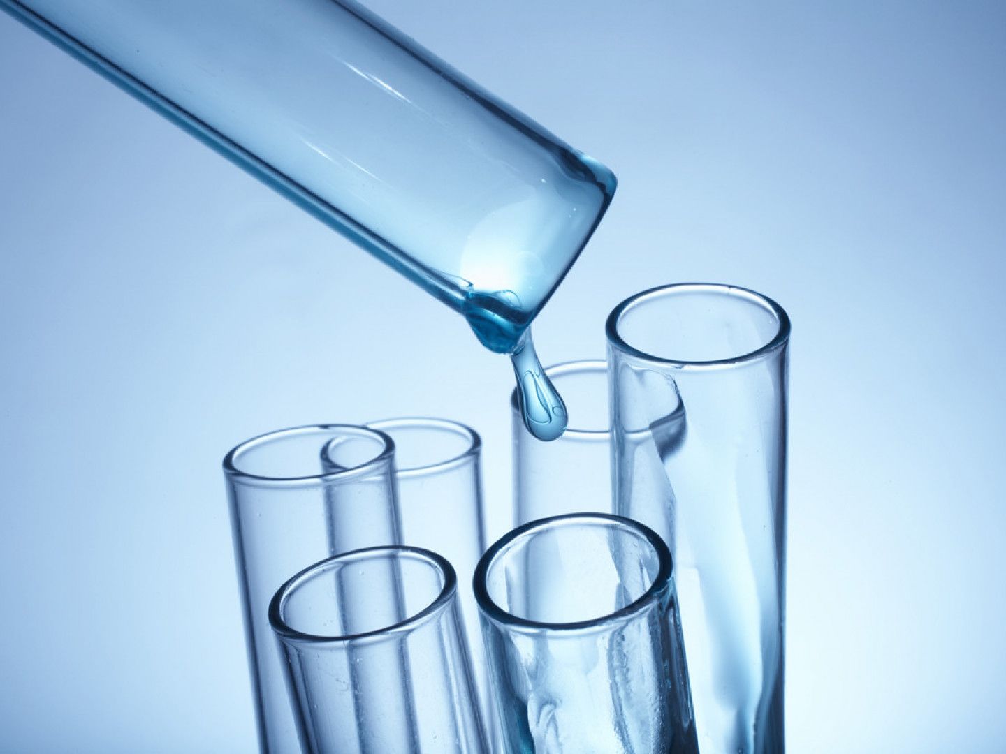 A drop of liquid is being poured into a test tube