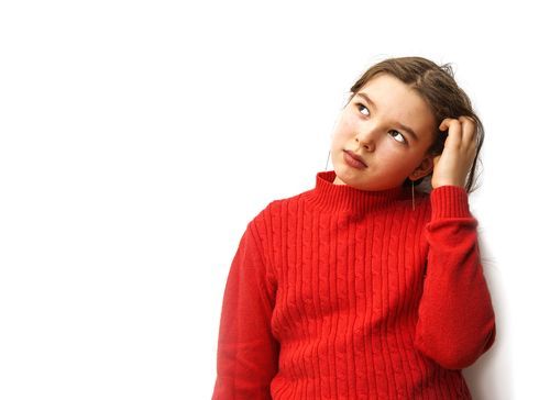 A young girl in a red sweater is scratching her head and looking up.