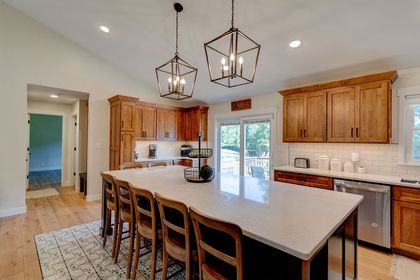 Half-finished room undergoing renovation: exposed wall, doorway, bags of materials, light wood flooring.