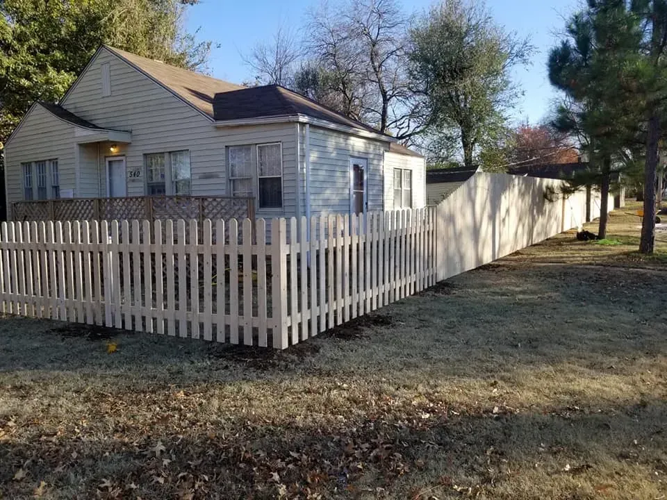 White picket fence surrounding a residential home in Oklahoma City — installed by Legacy Fence
