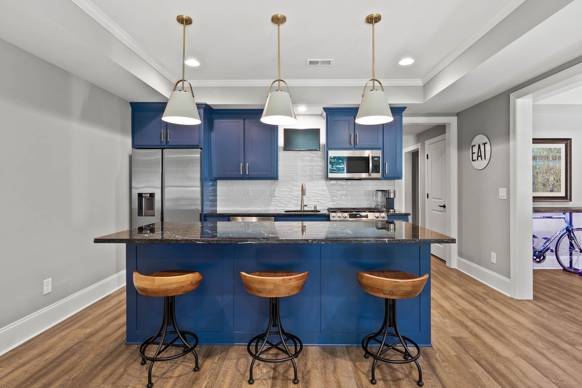 a kitchen with blue cabinets and a sign that says eat