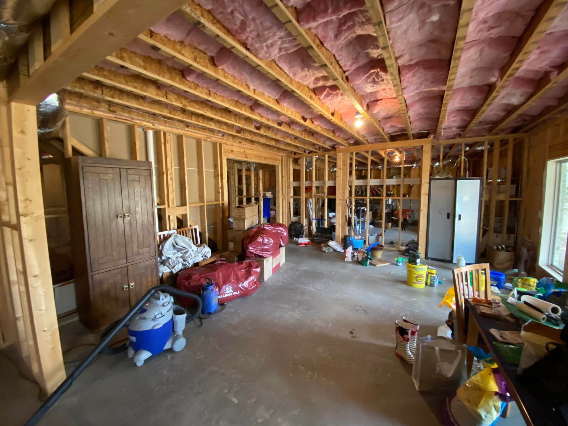 a room with a vacuum cleaner and a bag that says ' cleaning supplies ' on it
