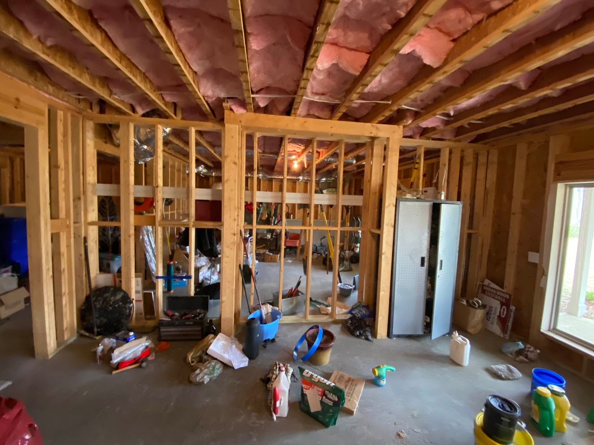 a room in a house under construction with a bucket that says ' eagle ' on it