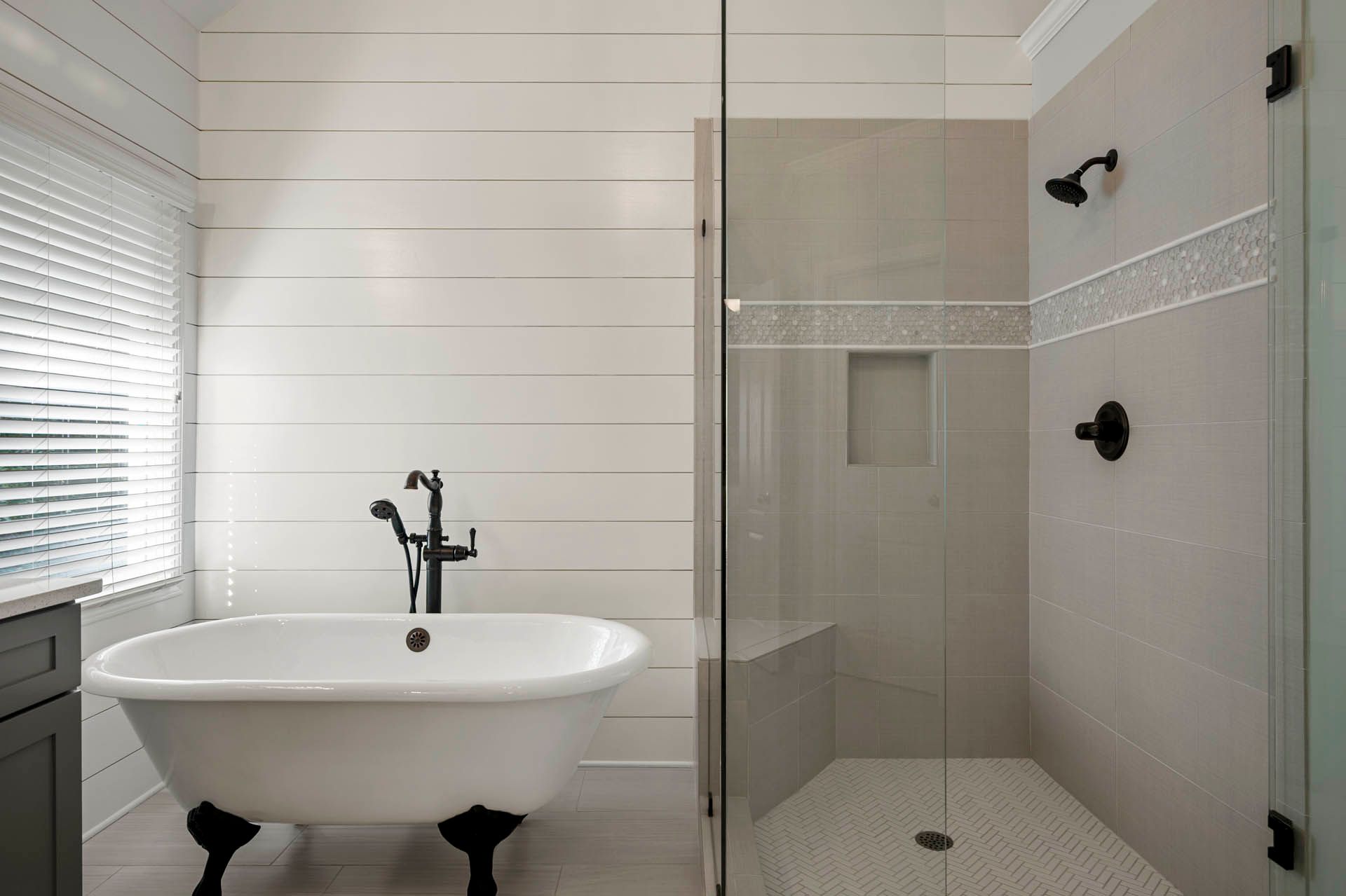 a bathroom with a tub and a walk in shower