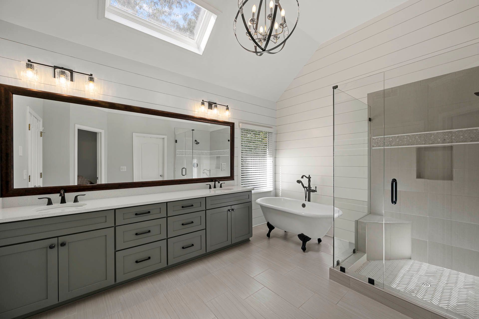 a bathroom with two sinks and a claw foot tub