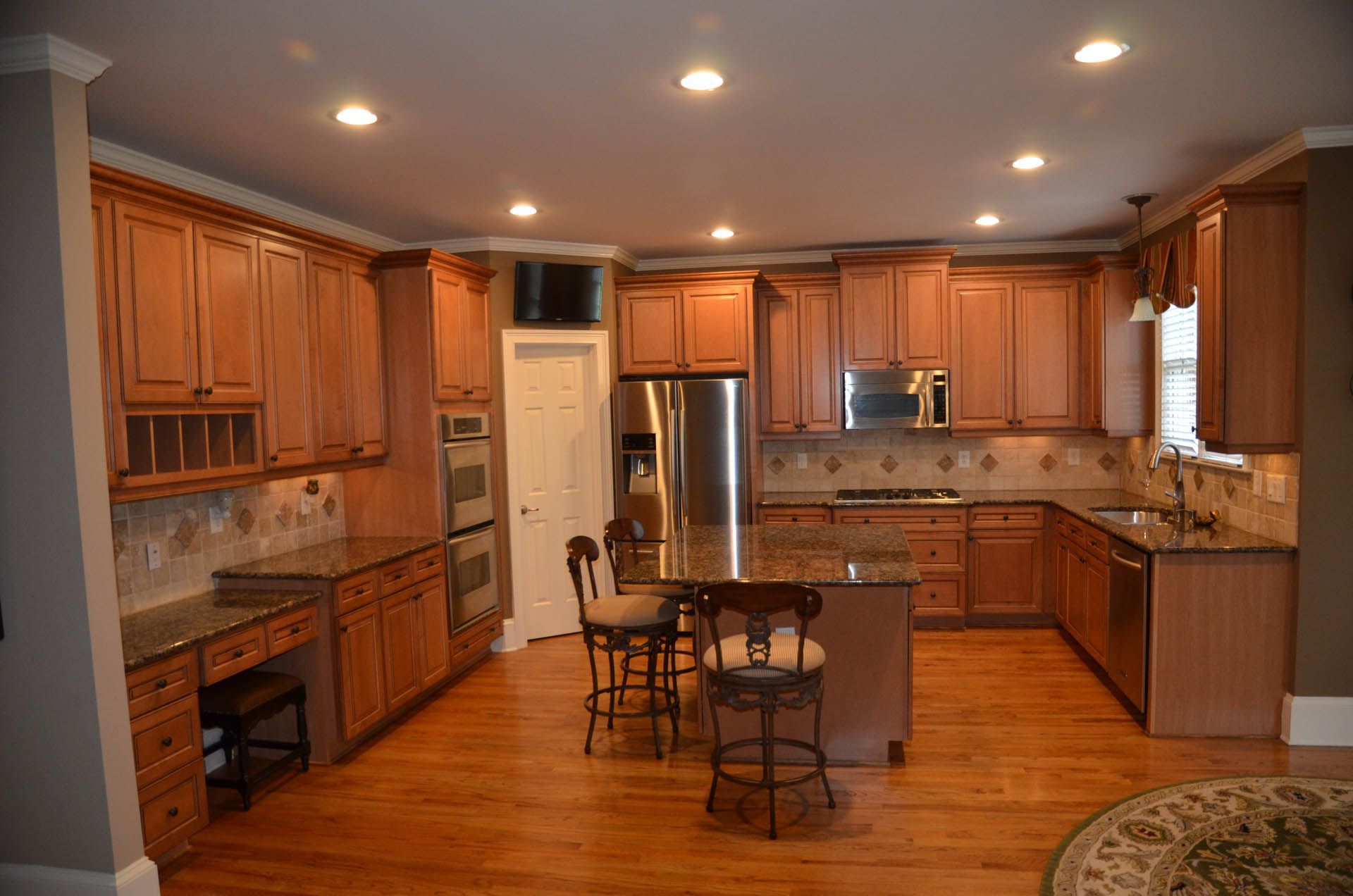 a kitchen with stainless steel appliances and granite counter tops