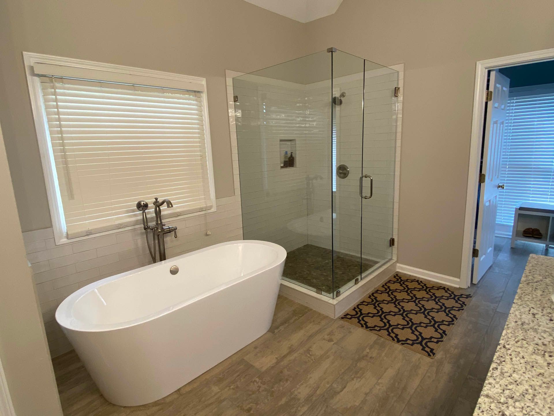 a bathroom with a tub and a walk in shower