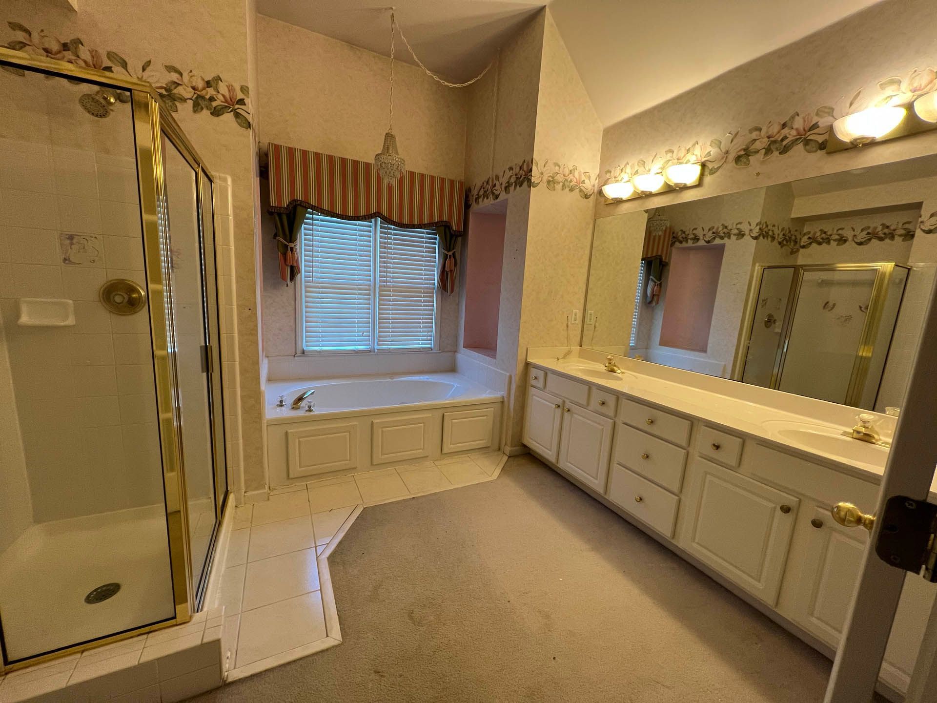 a bathroom with two sinks a tub and a shower