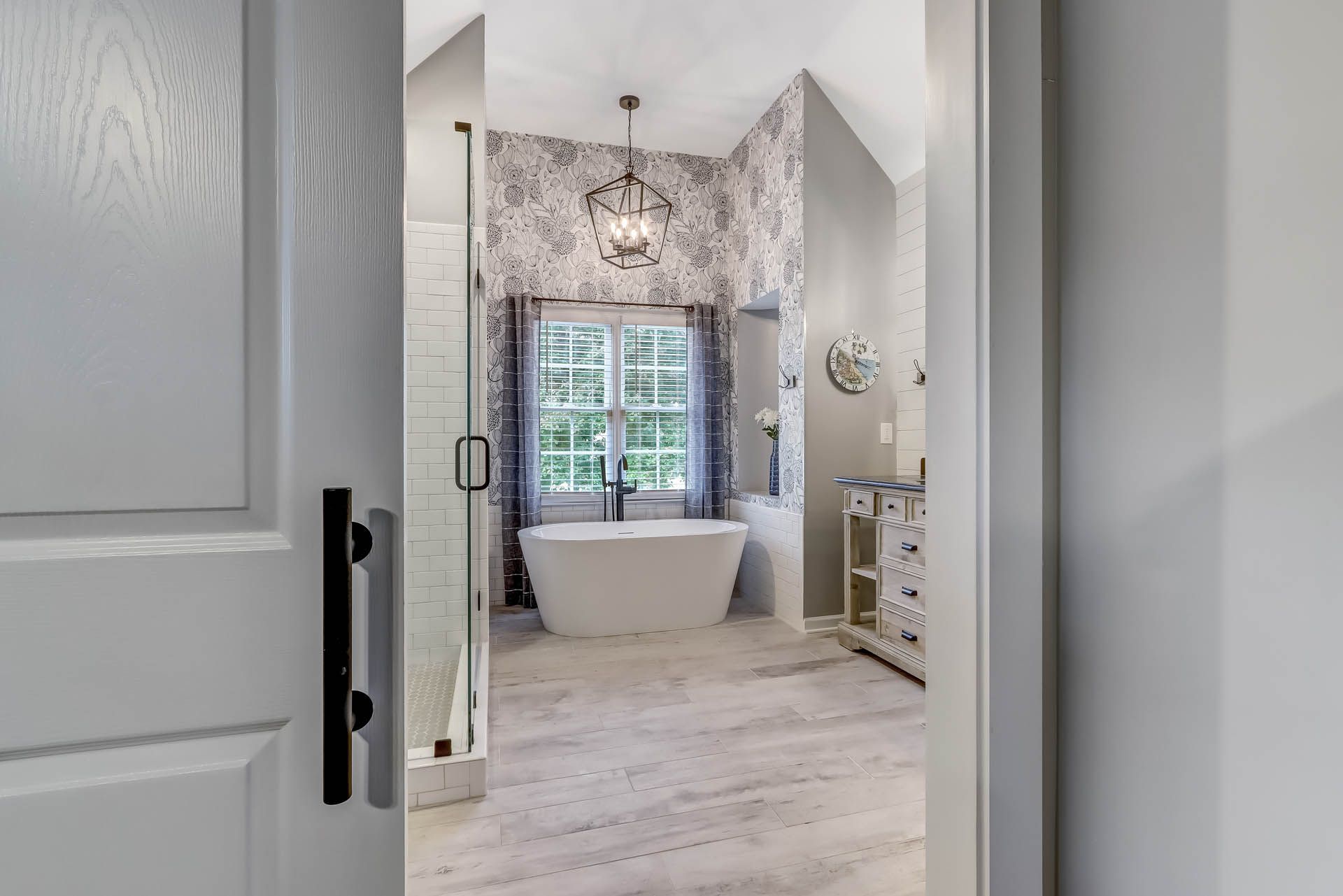 a bathroom with a tub and a lantern hanging from the ceiling