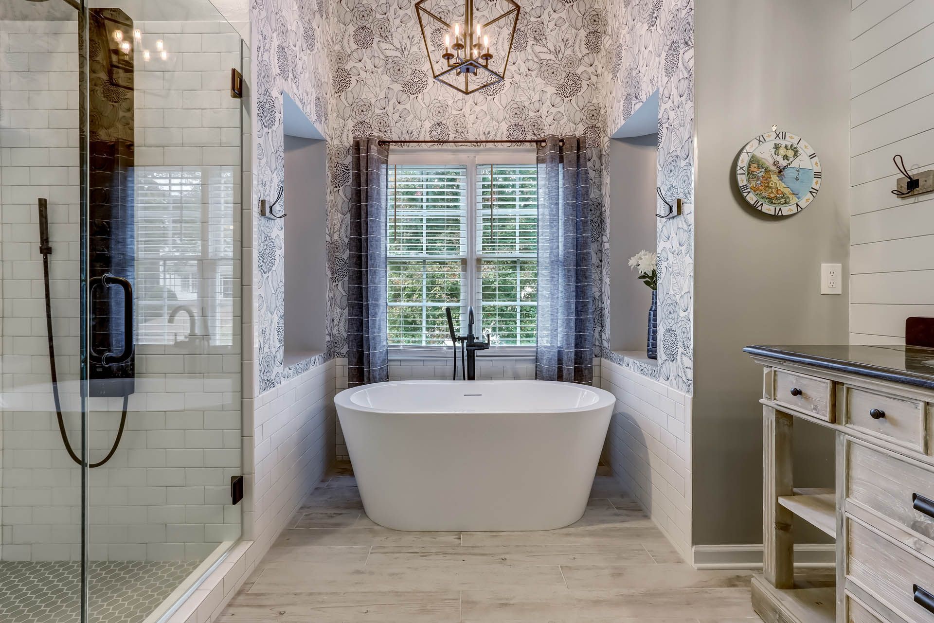 a bathroom with a bathtub and a clock on the wall