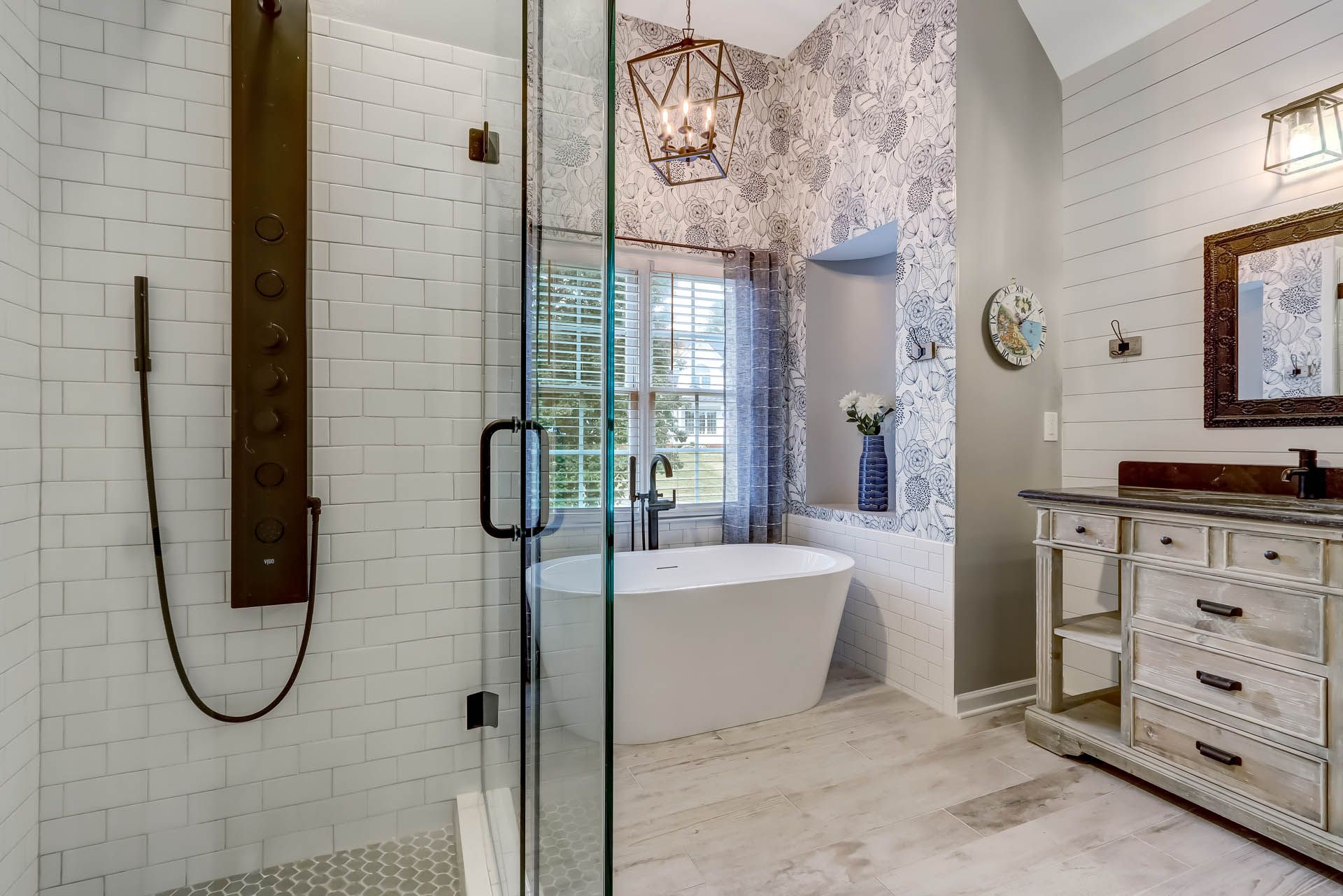 a bathroom with a bathtub and a walk in shower