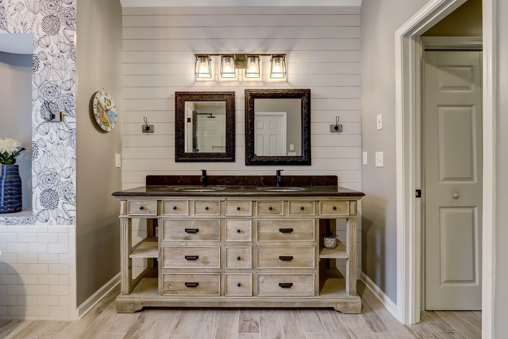 a bathroom with two sinks and two mirrors