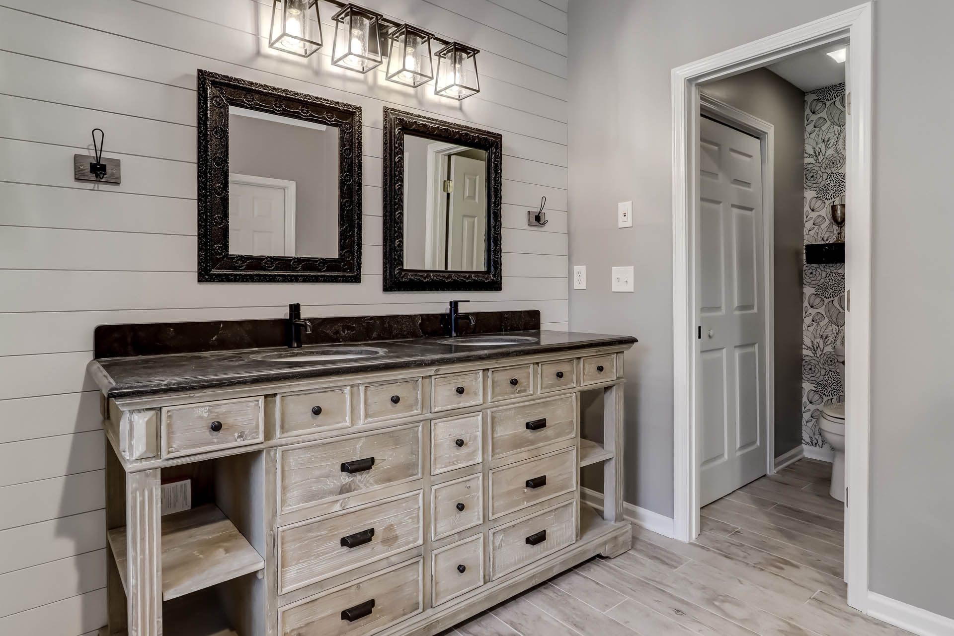a bathroom with two sinks and two mirrors