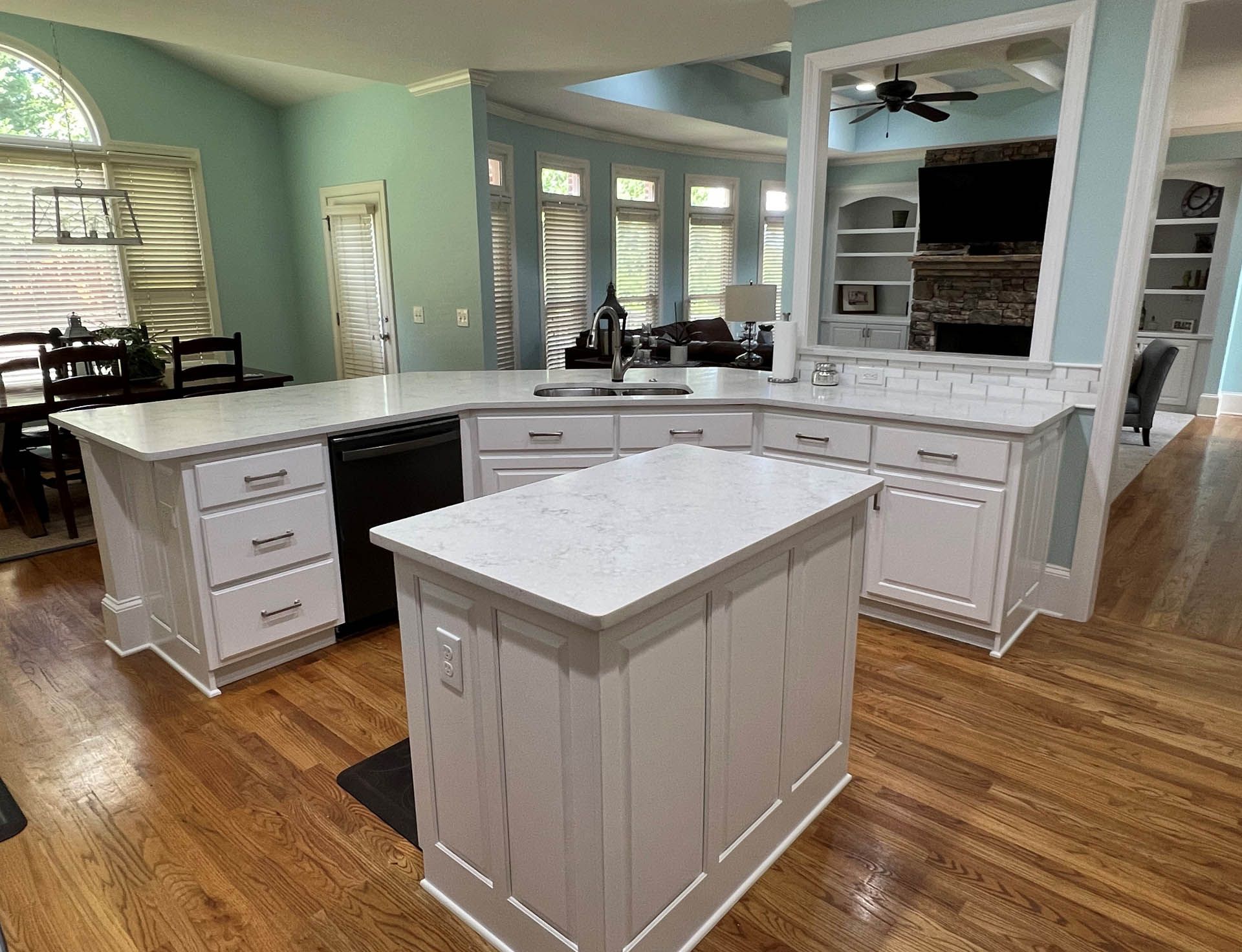 a kitchen with white cabinets and white counter tops