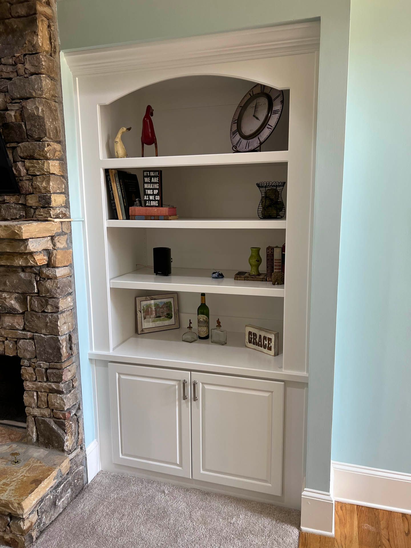 a shelf with a sign that says grace on it