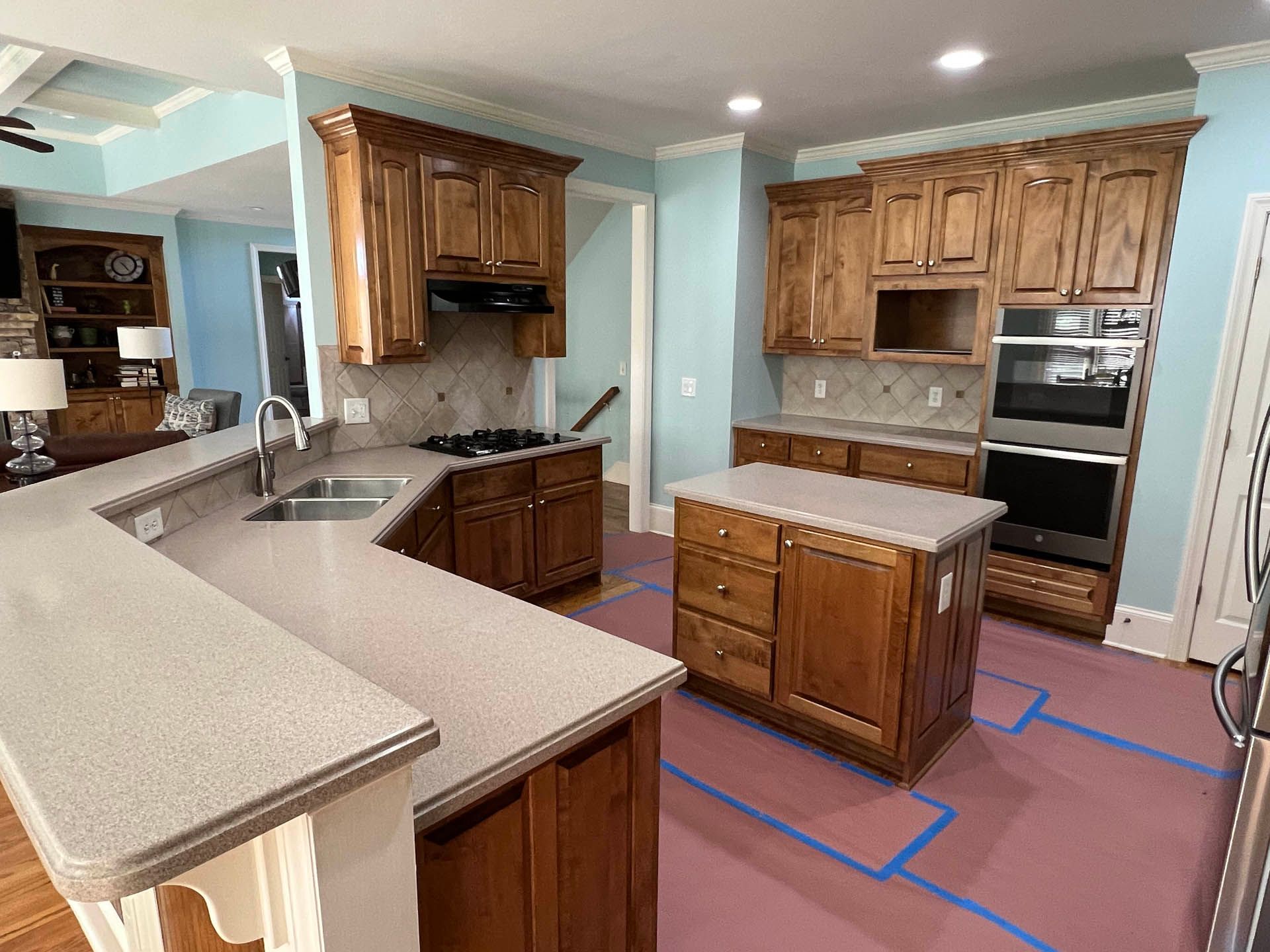 a kitchen with wooden cabinets and granite counter tops