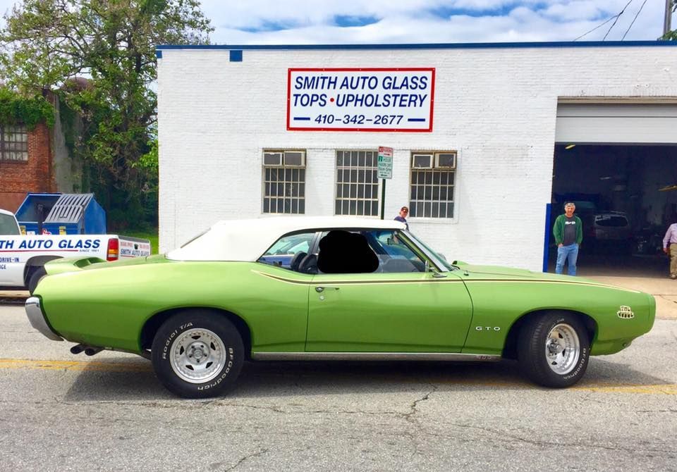 a green car that had service done sitting in front of smith auto glass