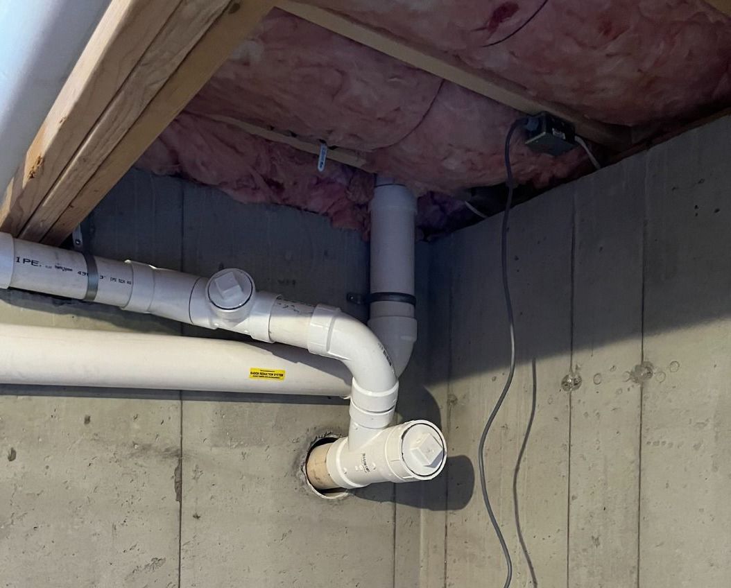 A bunch of pipes are connected to a wall