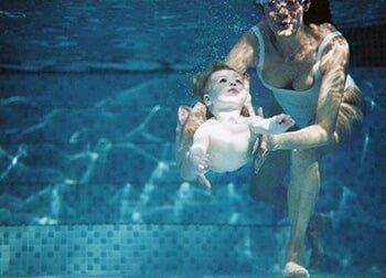 Baby Being Taught to Swim – Pool and Spa Shop in Lanesborough, MA Baby Being Taught to Swim – Pool and Spa Shop in Lanesborough, MA