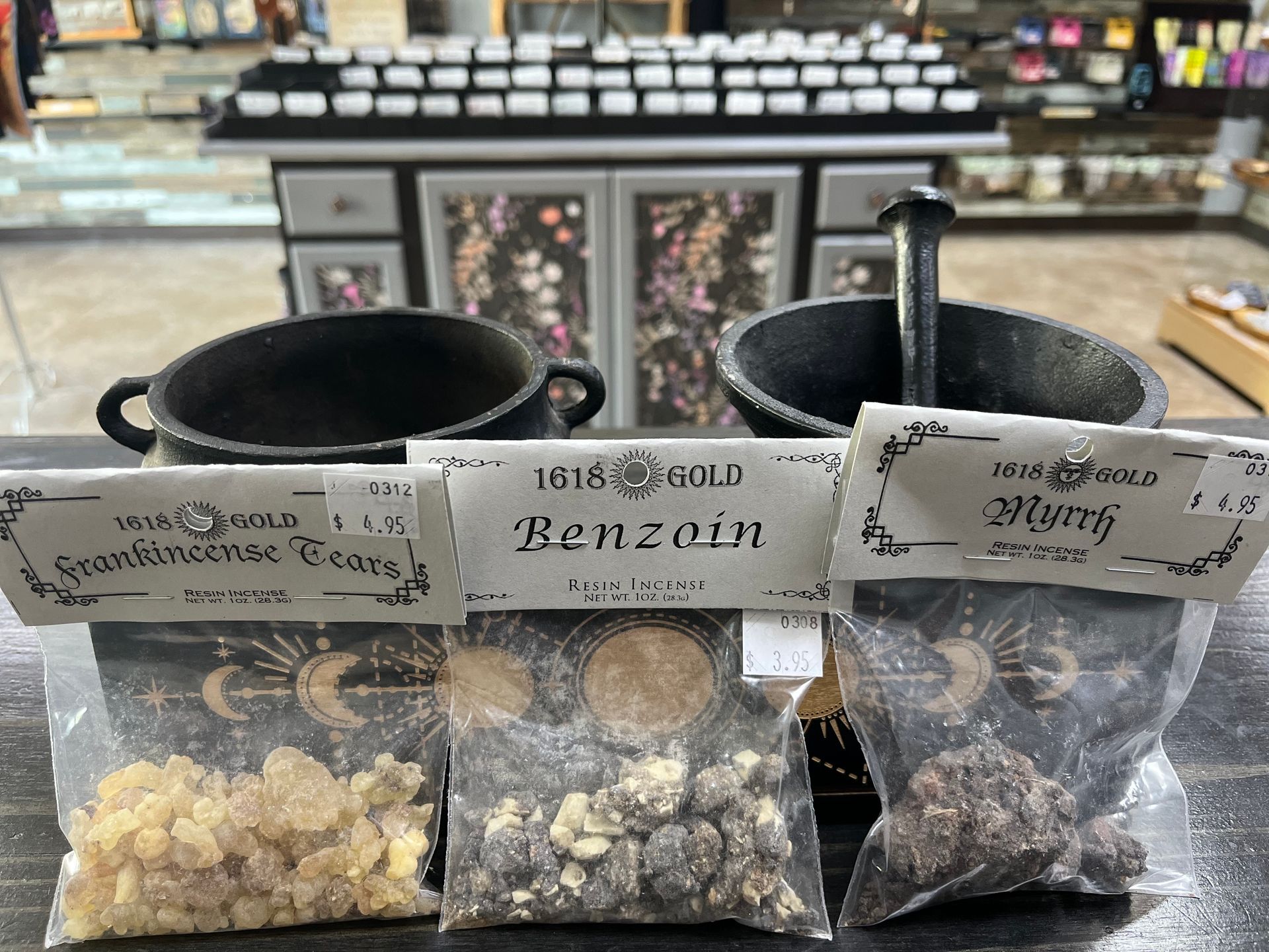 Three pouches of resin incense with mortar and pestle in shop.