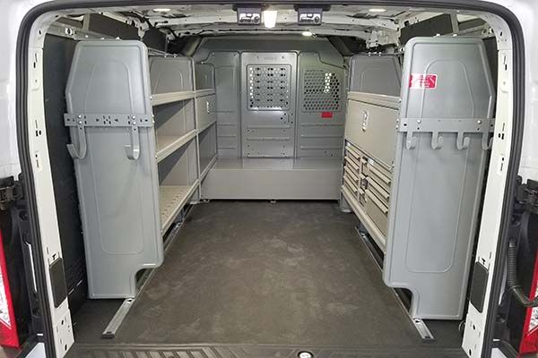 The inside of a van with shelves and drawers.