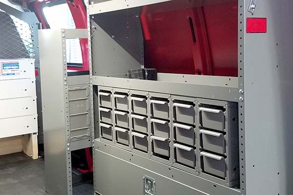 A van with a lot of shelves and drawers in it.