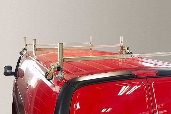 A red van with a ladder rack on the roof.