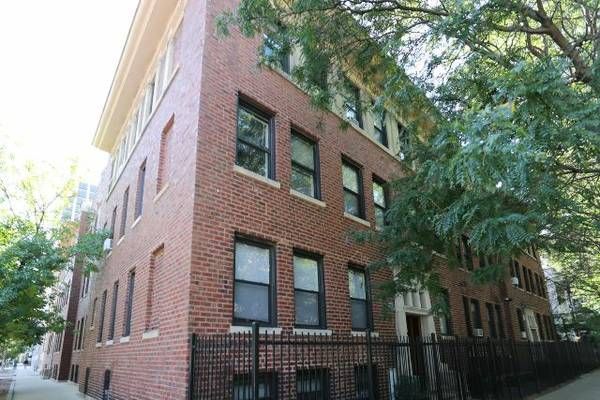 A large brick building with a fence around it