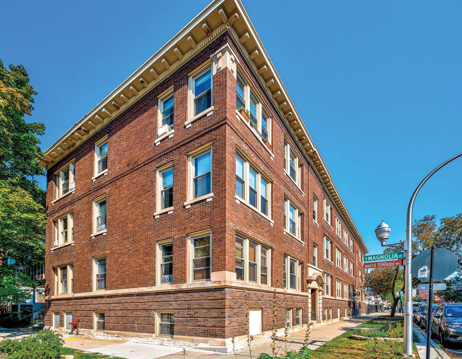 A large brick building with a lot of windows on a sunny day.