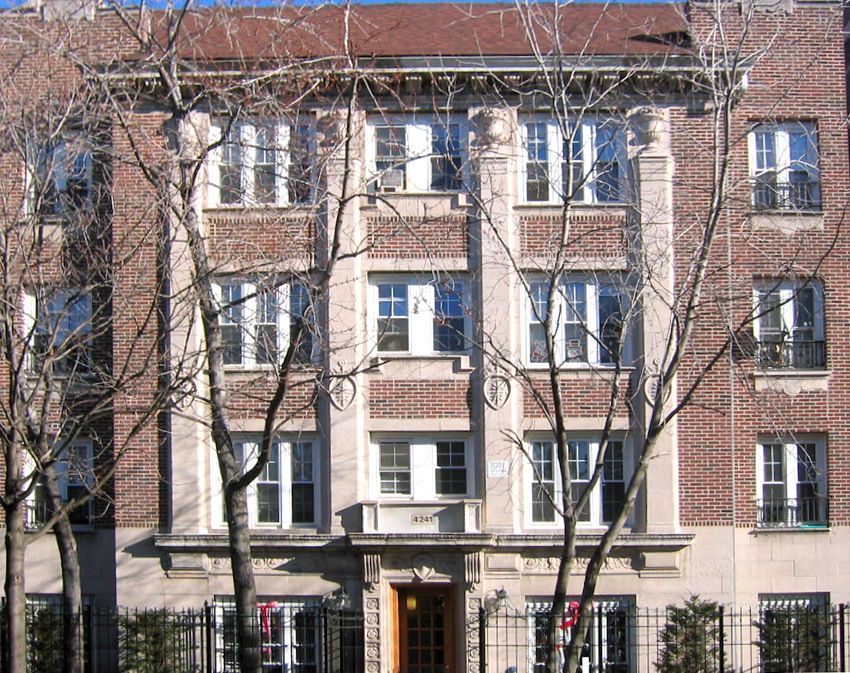 A large brick building with trees in front of it