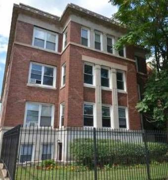 A large brick building with a fence around it.