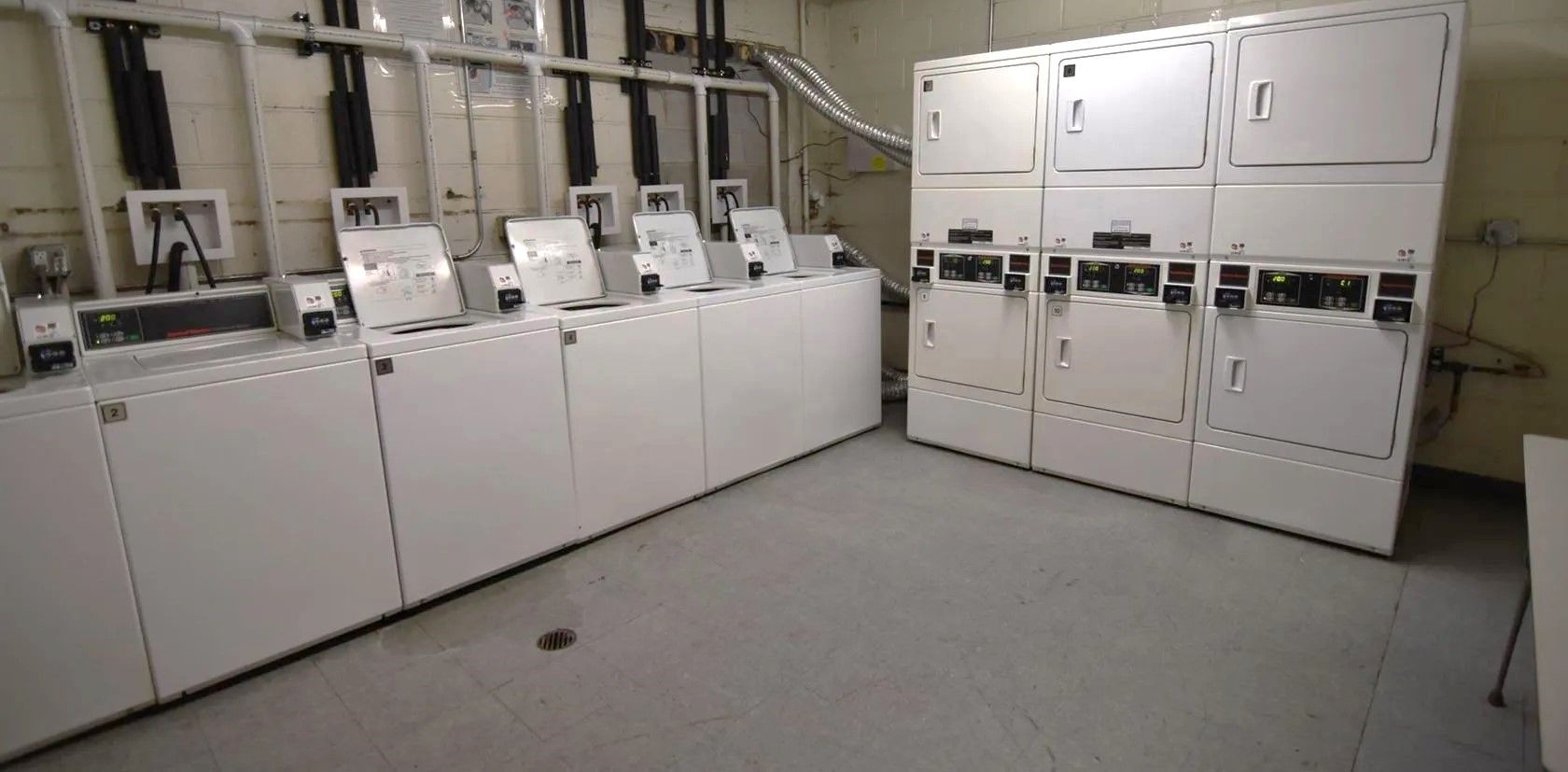 A laundromat filled with lots of washers and dryers.
