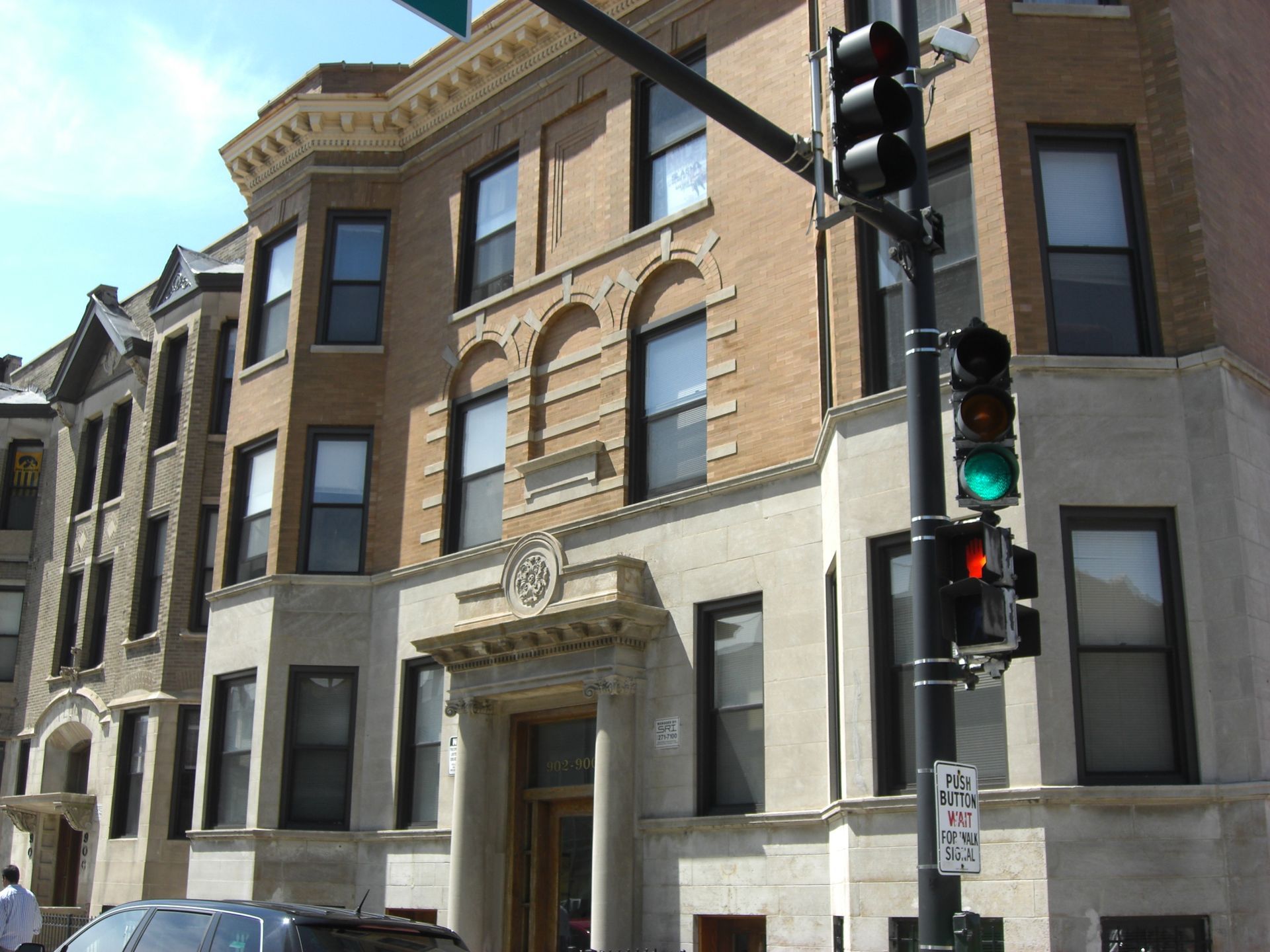 A brick building with a car parked in front of it