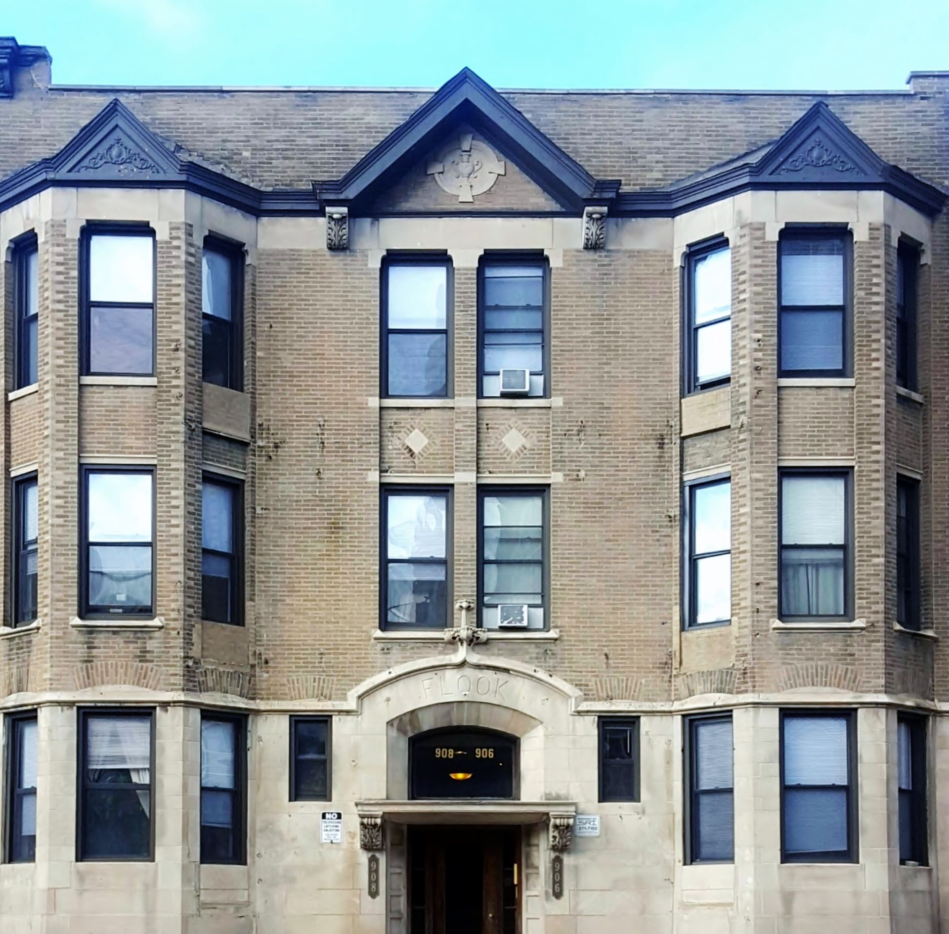 A large brick building with a clock on the top of it