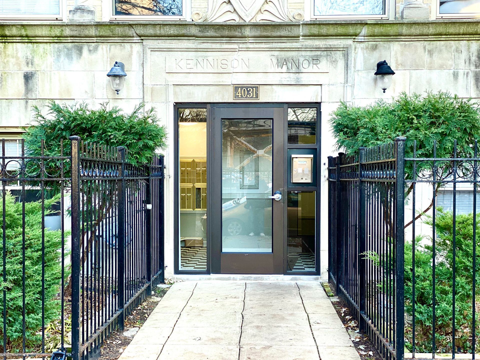 The front door of a building with a fence around it
