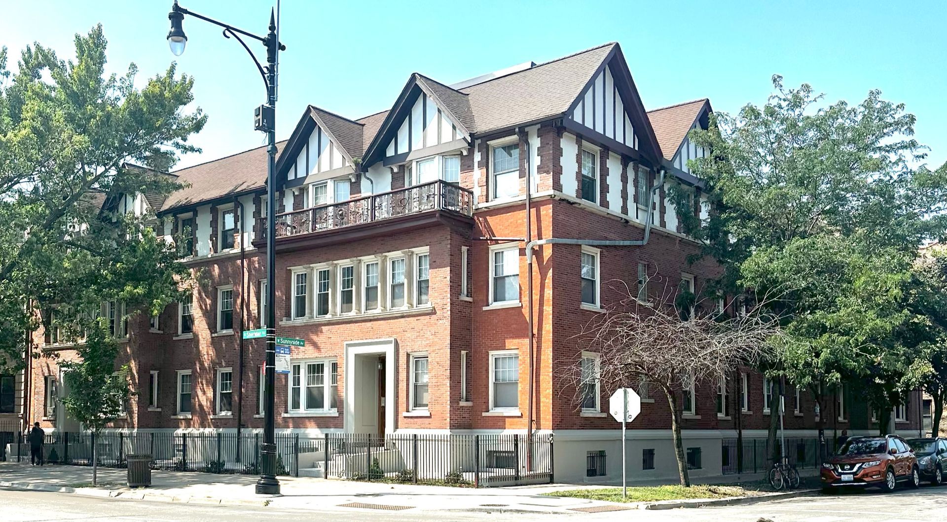 A large brick building with a street light in front of it