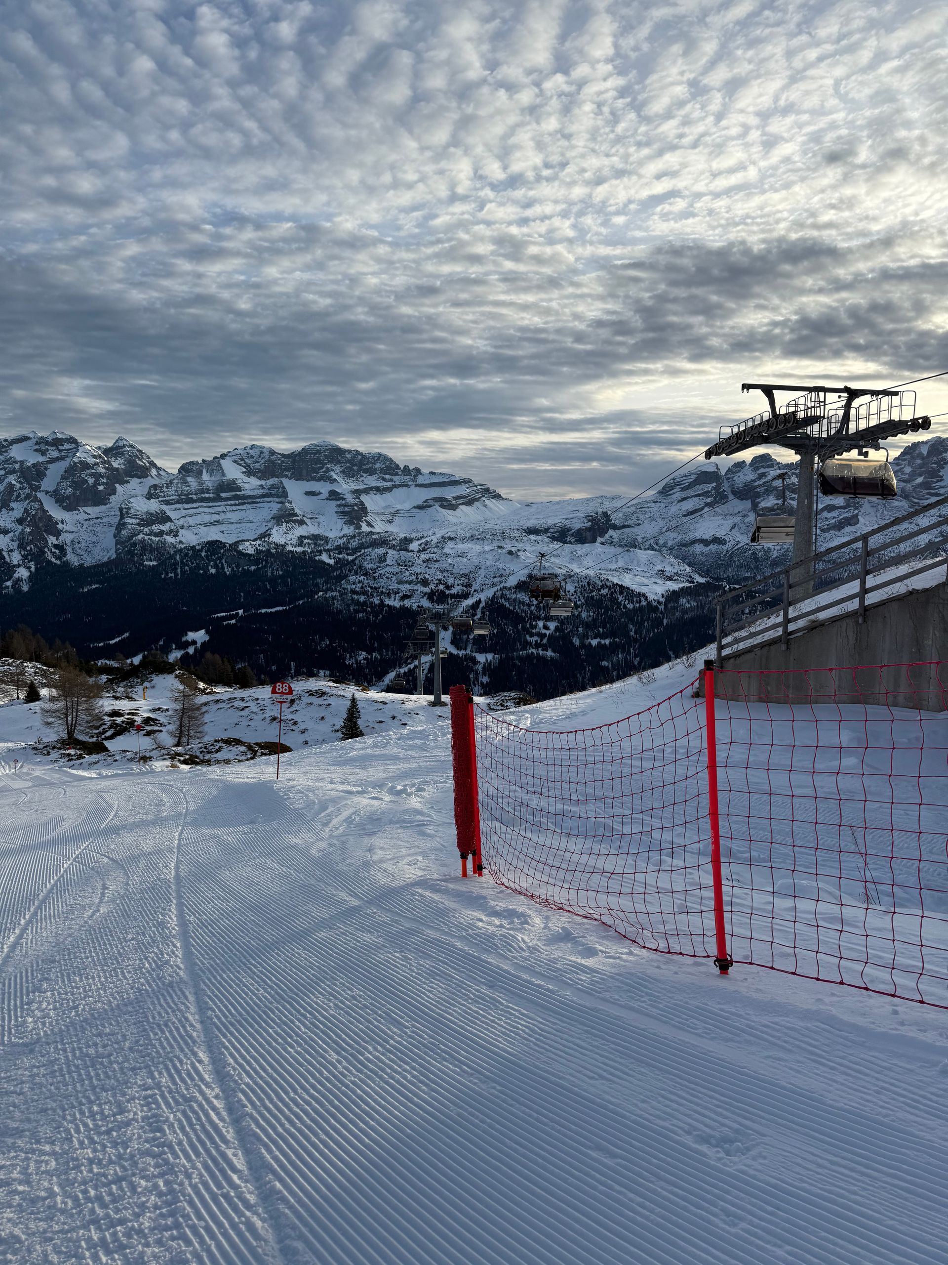 A ski lift is going up a snow covered mountain.