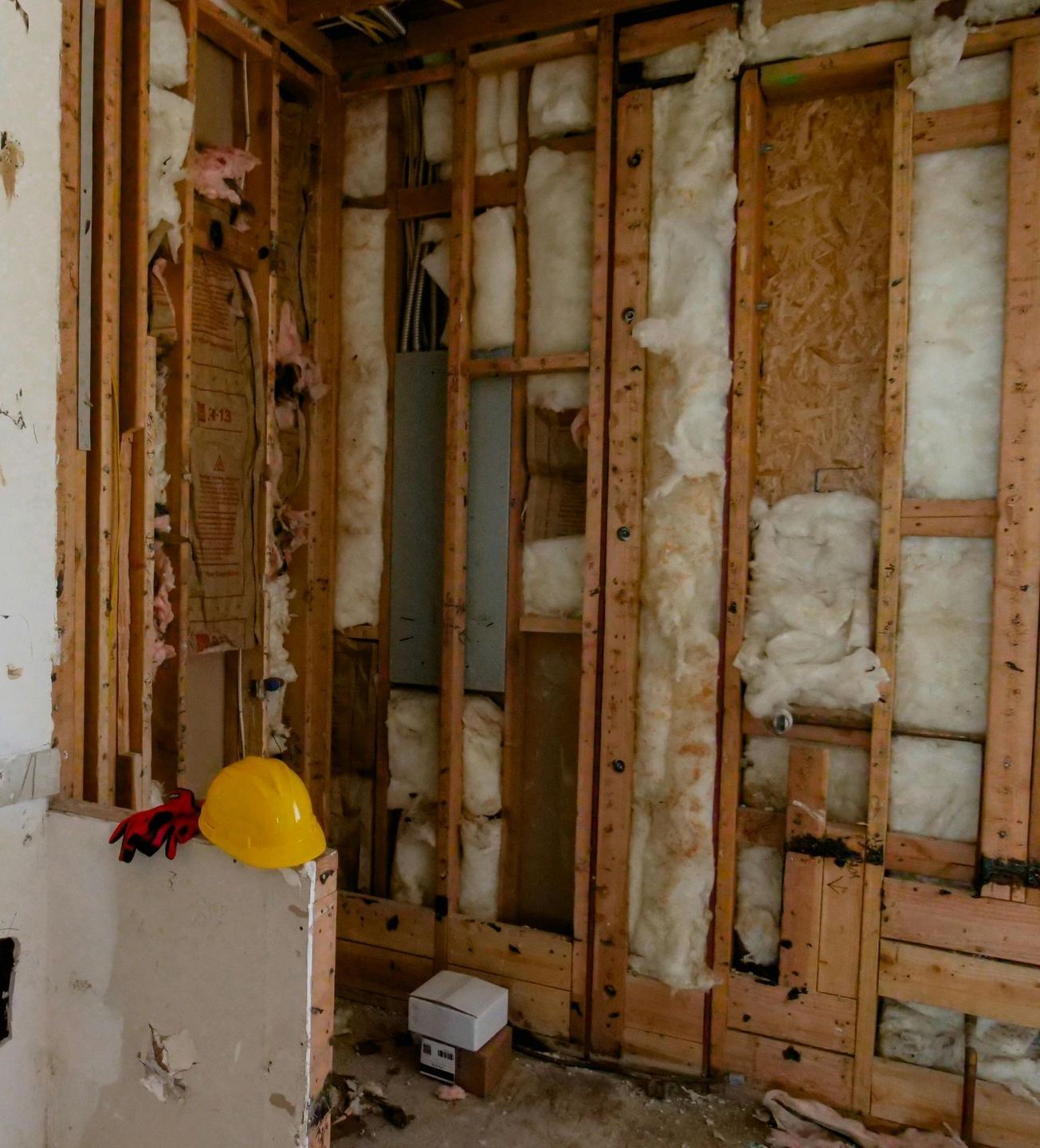 A yellow hard hat is sitting on a box in a room