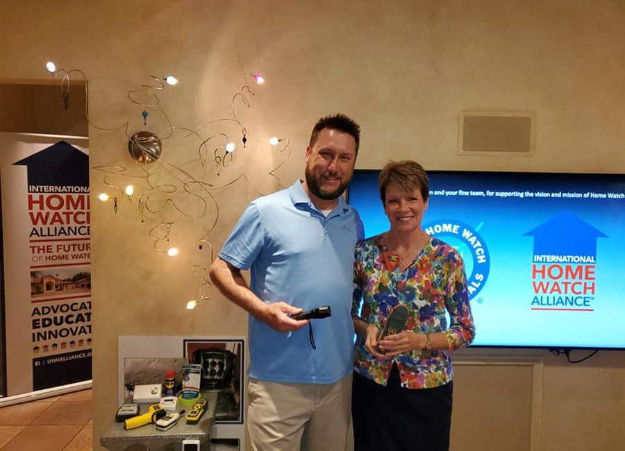 Diane and a Man Holding Tool — Naples, FL — Home Watch Academy