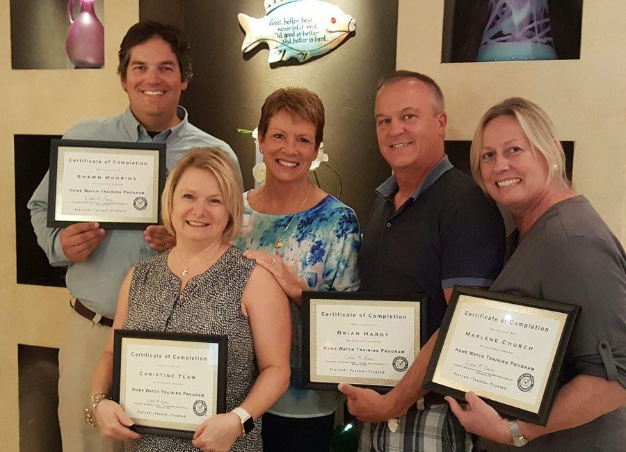 Trainees Holding Certificate of Home Watch Training Program — Naples, FL — Home Watch Academy