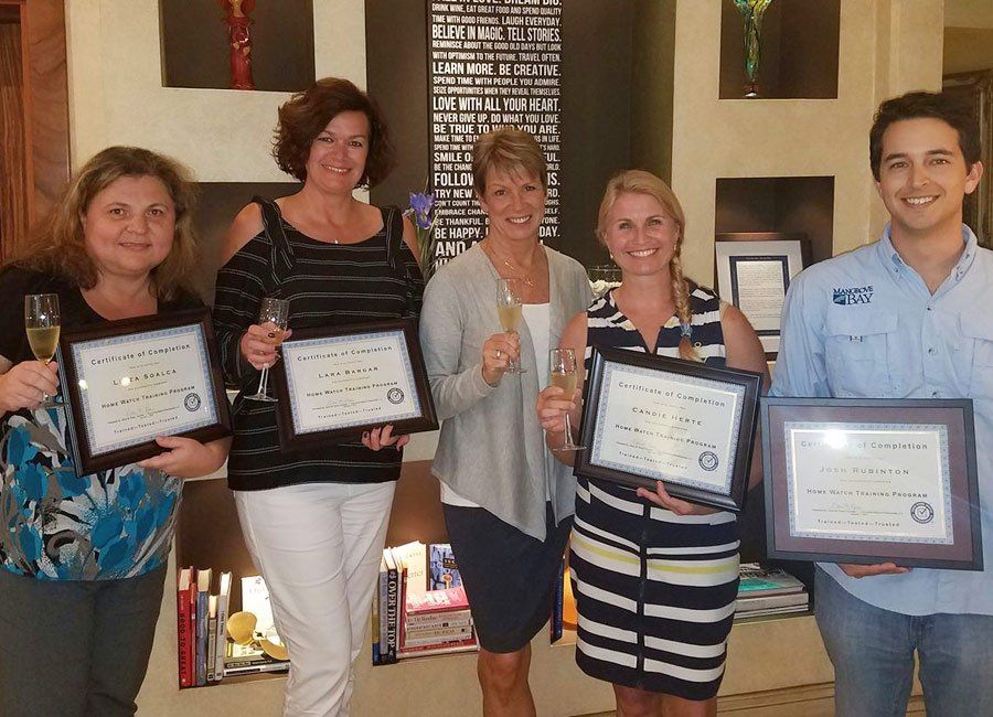 Trainees Holding Certificates — Naples, FL — Home Watch Academy
