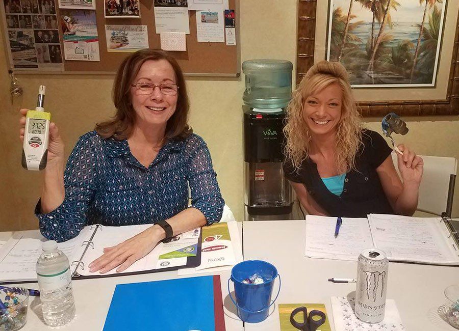 Two Women Sitting — Naples, FL — Home Watch Academy